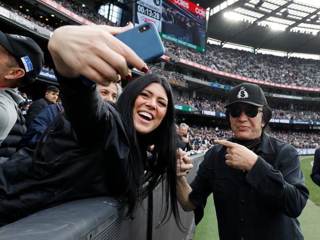 Carlton Blues fan Gene Simmons presents the match-day ball for the clash against the Collingwood Magpies at the MCG. Picture: Dylan Burns/AFL Photos via Getty Images