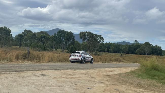 A police car parked on Station Rd, responding to reports of a man falling 20 metres from a collapsing wind tower near Lake Proserpine. Picture: Estelle Sanchez