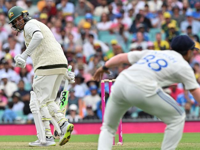 Usman Khawaja looks back after he was caught by KL Rahul on the final ball of day 1. Picture: Saeed KHAN / AFP