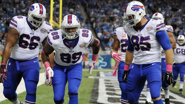 Chris Gragg #89, Seantrel Henderson #66 and Lee Smith #85 of the Buffalo Bills celebrate a fourth quarter touchdown.