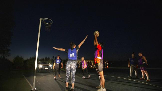 Car lights help the netballers play night matches at Ardmona. Picture: David Caird