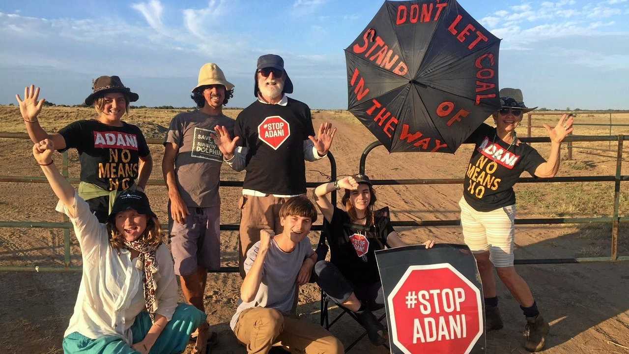 Front Line Action on Coal (FLAC) posted images of an Anti-Adani protest, captioned in part: Twenty people are blocking the access to the site of Adani's railway construction this morning, including three people, Kaiya, Bec and Ellie, who have locked on to the gates to stop work.