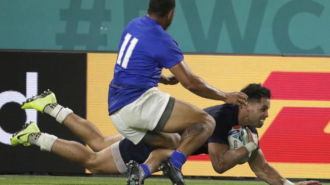 Samoa's Ed Fidow slides his knees into Sean Maitland late in the contest against Scotland.