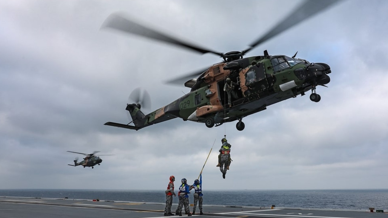 An MRH-90 helicopter practising winching operations with Aviation Support trainees on the HMAS Adelaide. Picture: Royal Australian Navy