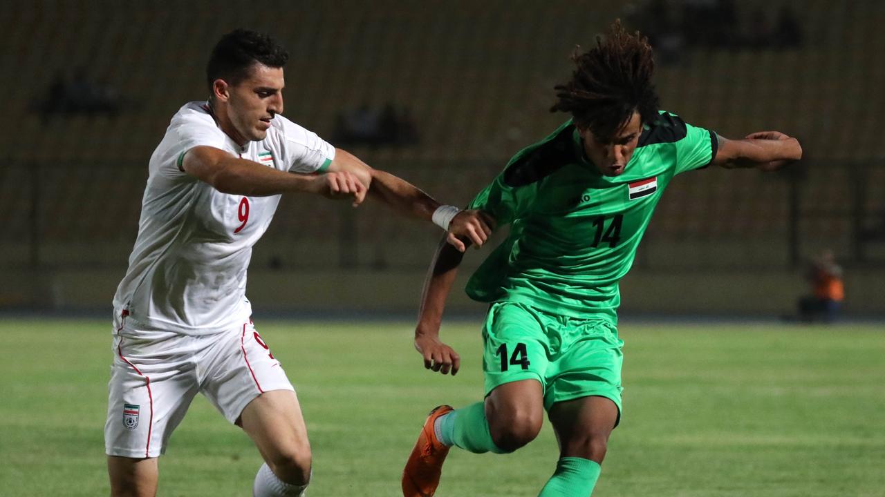 An Iraqi youth player (R) in action against Iran