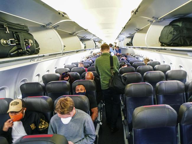 Masked passengers and spare seats. Domestic flights have changed in ways that nobody saw coming. Picture: Sandy Huffaker/Getty Images