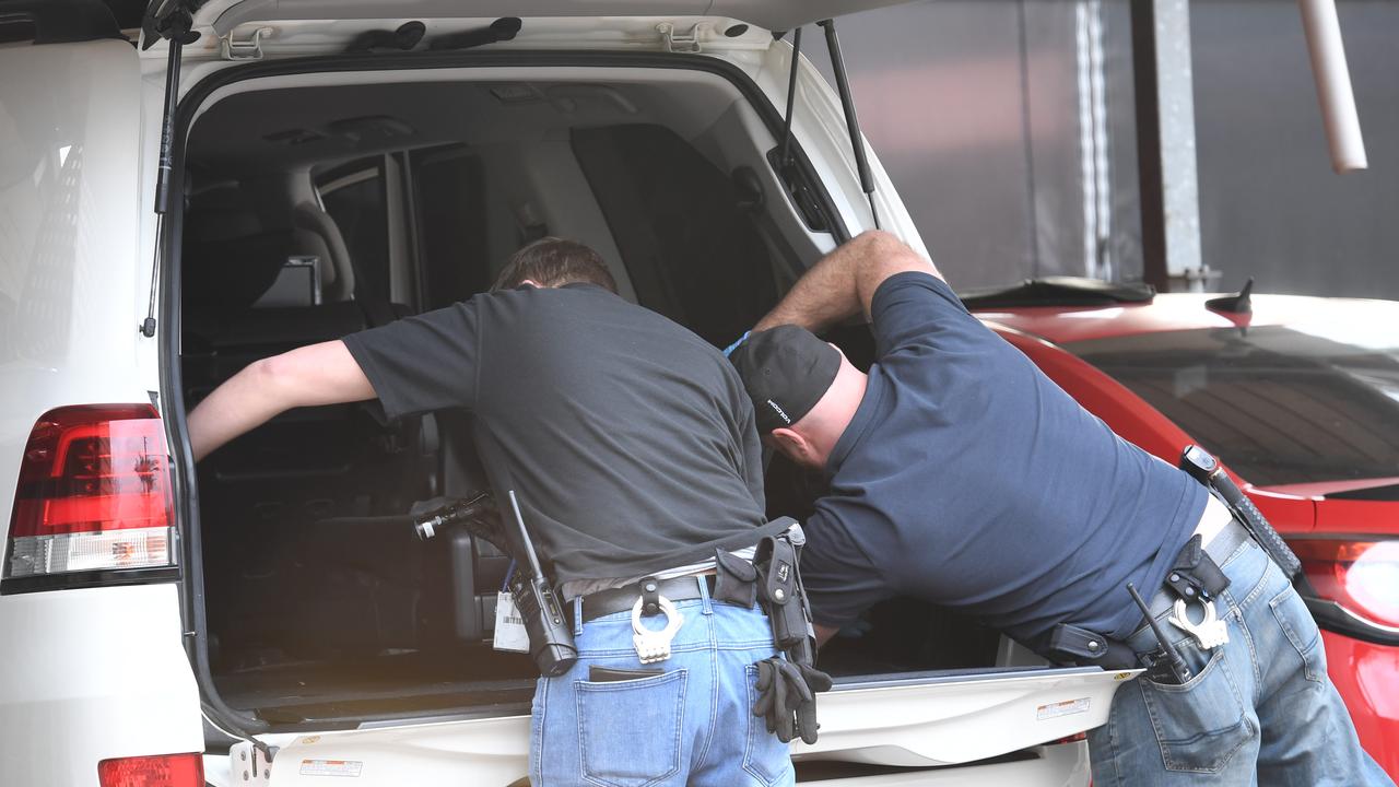 Detectives conduct a search at a property in Goodwood on Friday.