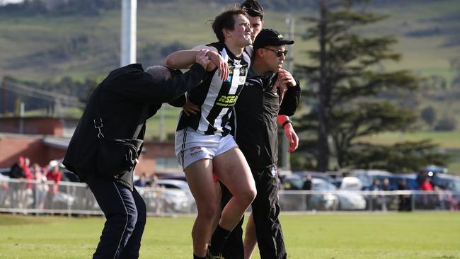 Aiden Grace is carried off the field after injuring his leg in a contest in the TSL game between Clarence v Glenorchy at Richmond Oval. Picture: Zak Simmonds