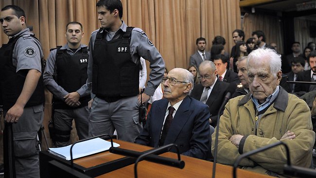 Former Argentina's dictator and General Jorge Rafael Videla (seated, centre), former general and member of the military junta, Reynaldo Bignone (right) wait at the courtroom before receiving the sentences in 2012 for their responsibility in an orchestrated plan to kidnap children from people disappeared during the military dictatorship (1976-83)  AFP / Juan Mabromata