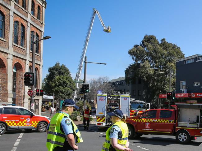 SYDNEY, AUSTRALIA : Newswire Photos AUGUST 30 2023: Fire Crews and Police are on the scene of a fire which broke out at a unit complex above Bobbys Cafe on the corner of Ivy and Abercrombie streets in Darlington in Sydney around 8am today. Investigations are underway to find the cause of the fire. Picture: NCA Newswire/ Gaye Gerard