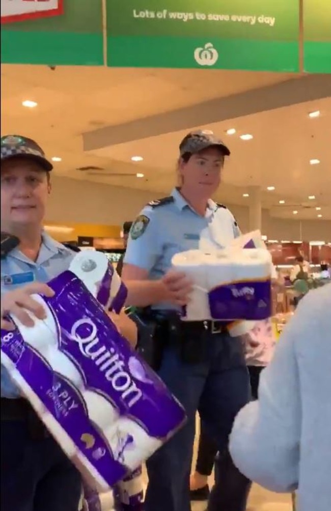 Police officers distributed toilet paper and paper towels at a Sydney supermarket earlier this month to calm panic buyers. Picture: Storyful