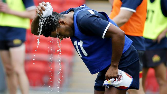 Gold Coast Suns’ Touk Miller trying to cool down at training.