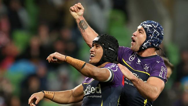 MELBOURNE, AUSTRALIA - JULY 20: Sualauvi Faalogo of the Storm celebrates scoring a try with Jahrome Hughes of the Storm during the round 20 NRL match between Melbourne Storm and Sydney Roosters at AAMI Park, on July 20, 2024, in Melbourne, Australia. (Photo by Kelly Defina/Getty Images)