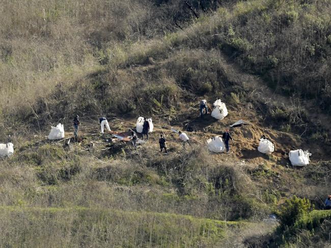 Investigators work at the scene of a helicopter crash that killed Kobe Bryant, his 13-year-old daughter, Gianna, and seven others, in Calabasas. Picture: AP