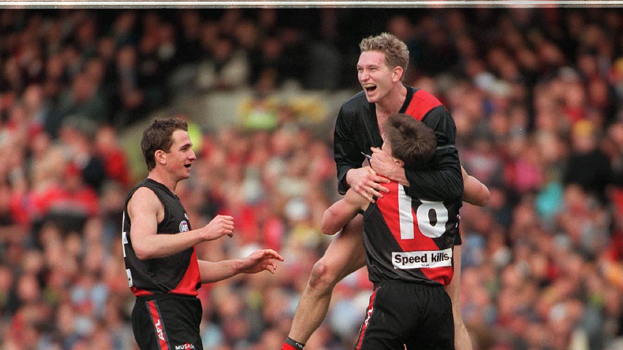 Joe Misiti, James Hird and Matthew Lloyd in the 2000 Grand Final.