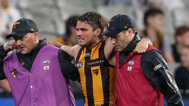 MELBOURNE, AUSTRALIA – APRIL 01: Nick Watson of the Hawks leaves the field injured during the 2024 AFL Round 03 match between the Hawthorn Hawks and the Geelong Cats at the Melbourne Cricket Ground on April 01, 2024 in Melbourne, Australia. (Photo by Dylan Burns/AFL Photos via Getty Images)