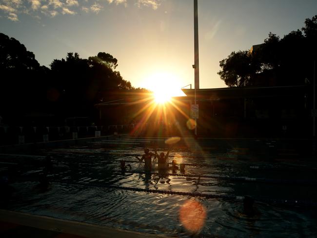 The sun sets on Parramatta pool as locals hold a party to celebrate.