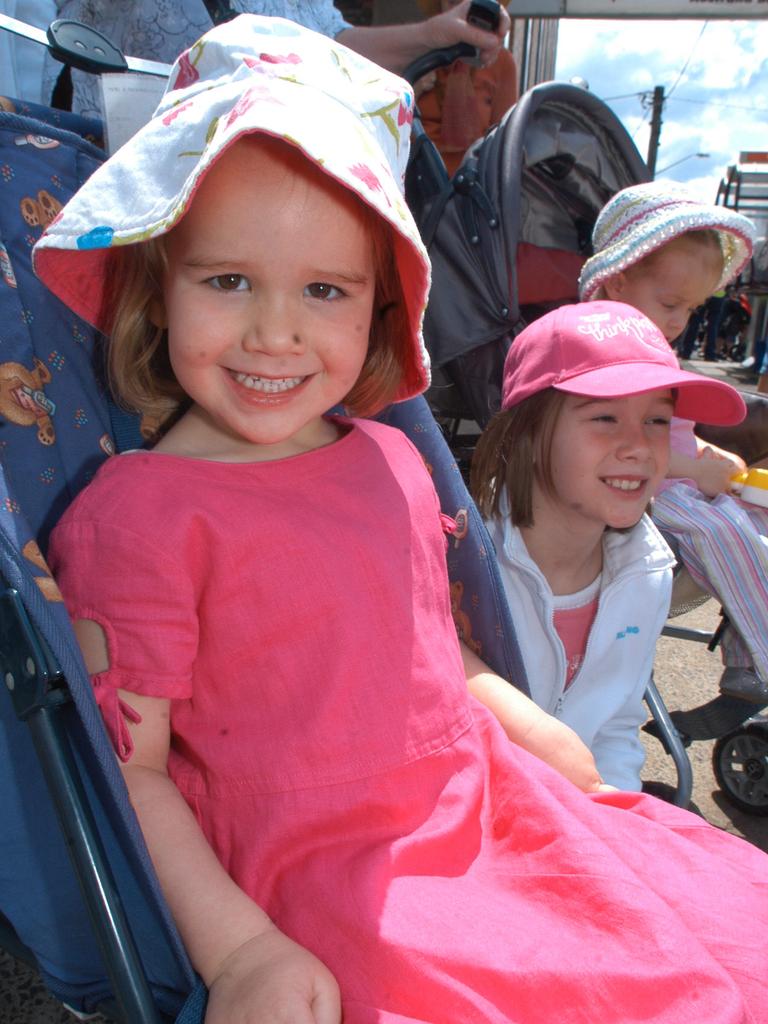 Sisters Hannah Meyer 3yr and Emma Meyer 9yr are all smiles as the 58th Toowoomba Carnival of Flowers Street Parade as it makes its way through the City. Picture: David Martinelli.