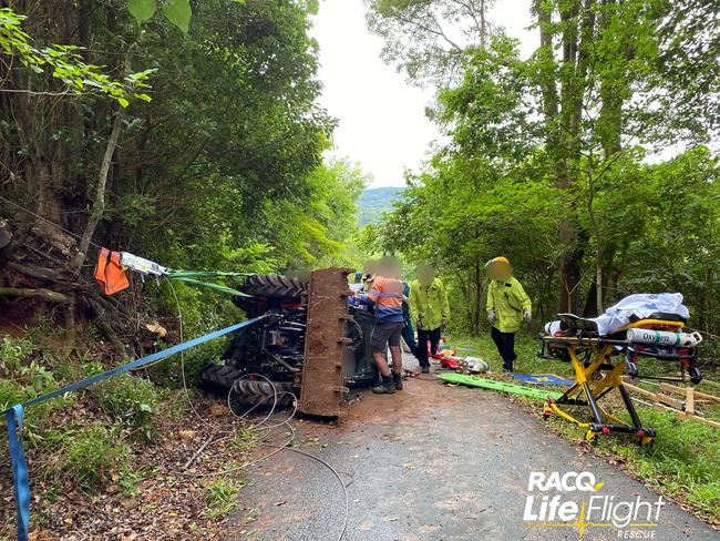 A man was pinned underneath his rolled tractor for more than an hour today and was flown to hospital by the RACQ's LifeFlight Rescue. Photo: LifeFlight media. 