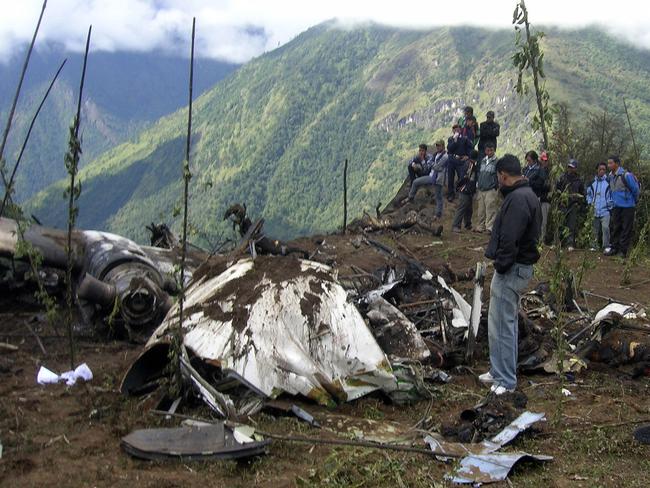 People stand around the wreckage of a Yeti Airlines plane in 2008.