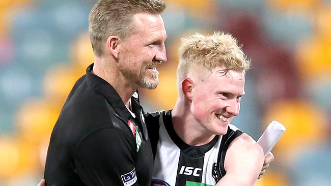 Collingwood coach Nathan Buckley celebrates the win over Carlton with John Noble.