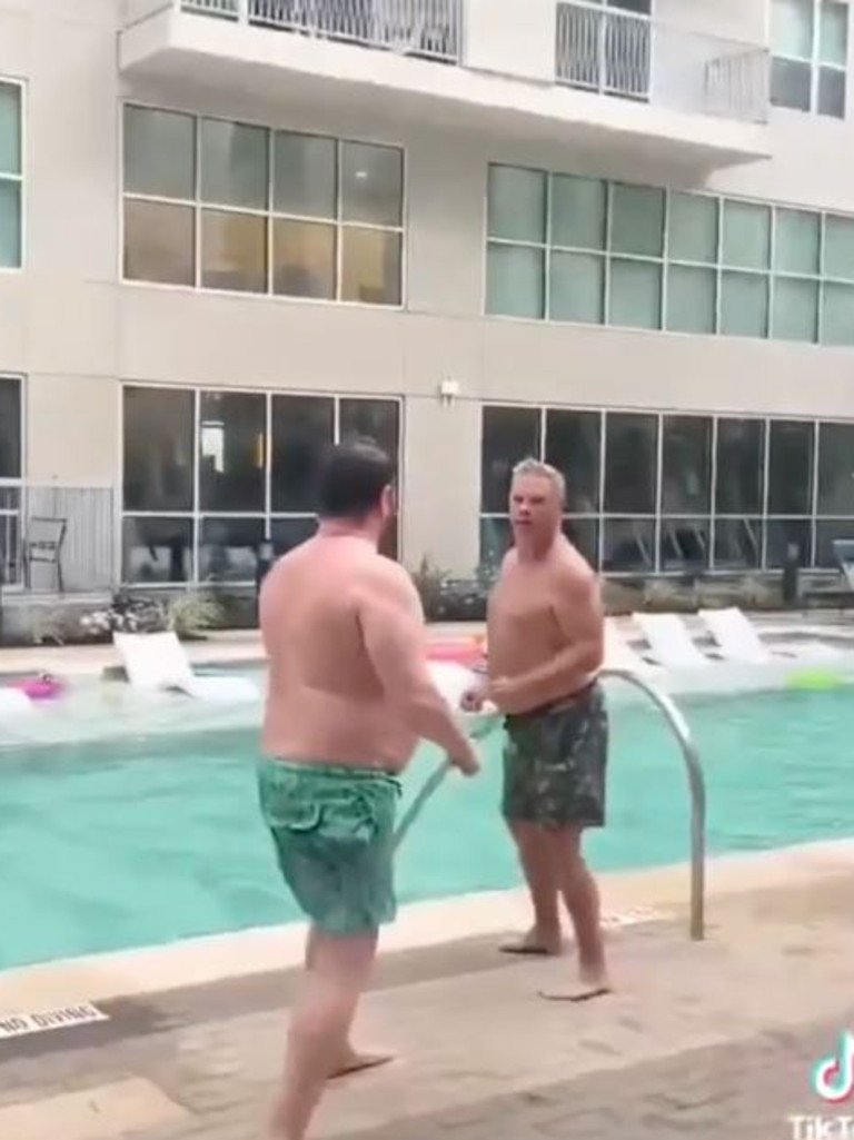 The embarrassing bust-up between the men in their swimming shorts was caught on camera at a family resort.