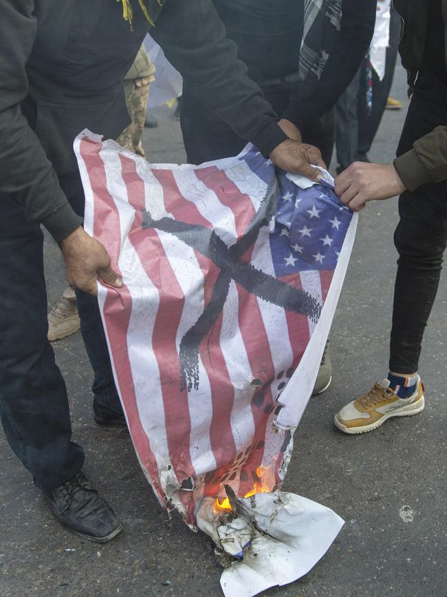 Mourners burn a US flag during the funeral of Qassem Soleimani and Abu Mahdi al-Muhandis. Picture: AP