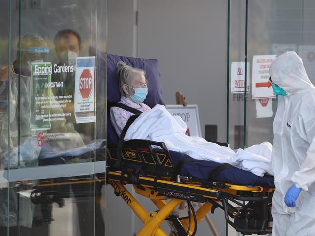 A resident is taken to transport out of Epping Gardens Aged Care home during a COVID-19 outbreak. Picture: NCA NewsWire