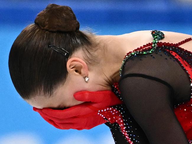 Russia's Kamila Valieva reacts after competing in the women's single skating free skating of the figure skating event during the Beijing 2022 Winter Olympic Games at the Capital Indoor Stadium in Beijing on February 17, 2022. (Photo by Anne-Christine POUJOULAT / AFP)