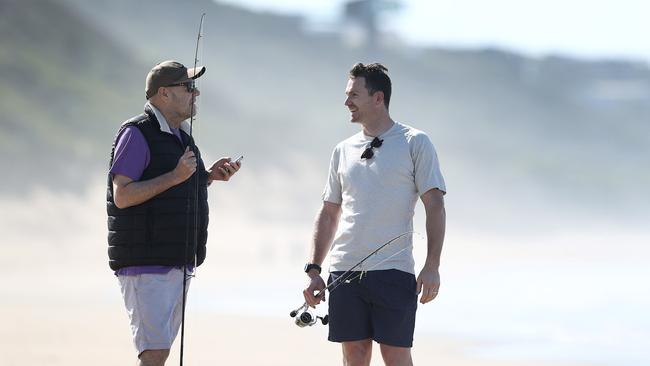 Patrick Dangerfield and Mark Robinson on the beach at Moggs Creek. Picture: Michael Klein.