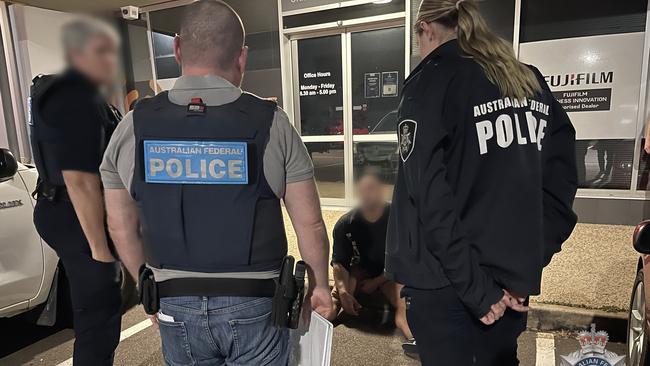 One of the alleged syndicate members being arrested by police in Darwin. Picture: AFP