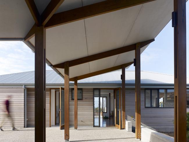 Architect Ashley Dunn said he had to convince council that moving the entrance to the rear (above), where the owner could enter easily, was preferable to trying to enter via the front steps of this far South Coast home. Picture: Kilian O’Sullivan