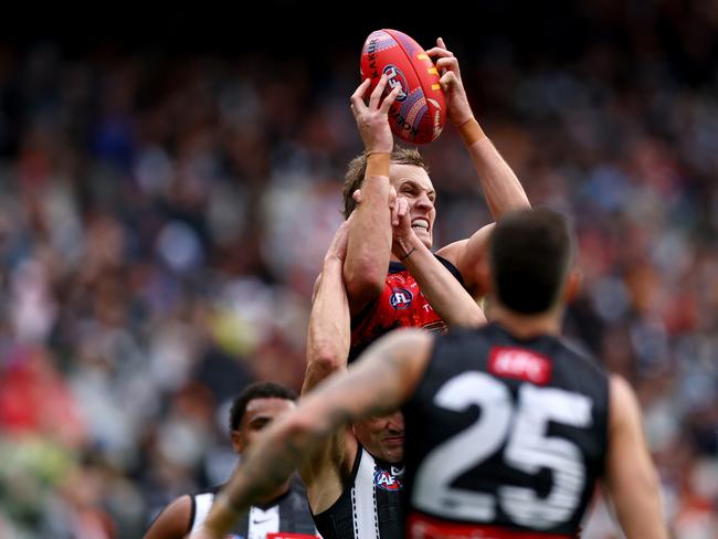 Crows skipper Jordan Dawson climbs high to mark over a pack.