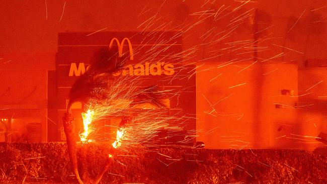 A McDonald's restaurant is showered in embers during the Eaton fire in Pasadena. Picture: AFP