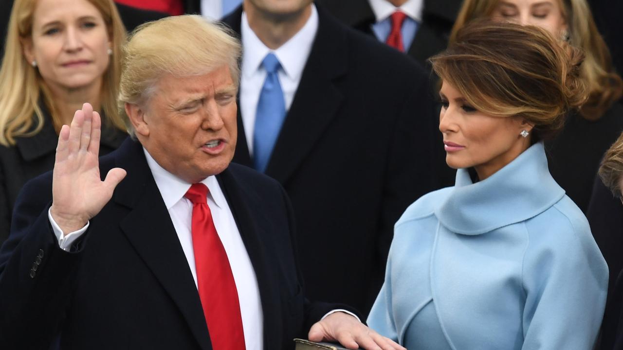 Donald Trump, with his wife Melania Trump, is sworn in as President at the US Capitol in Washington, DC in 2017. (Photo by Mark RALSTON / AFP)