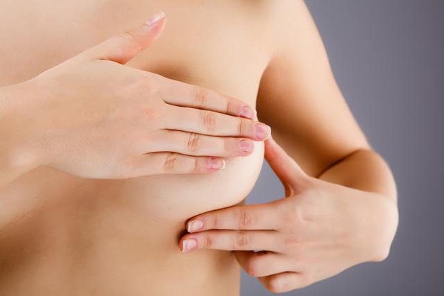 Woman examining her breast