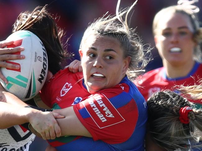NEWCASTLE, AUSTRALIA - SEPTEMBER 09: Caitlan Johnston of the Knights is tackled during the round eight NRLW match between Newcastle Knights and Sydney Roosters at McDonald Jones Stadium on September 09, 2023 in Newcastle, Australia. (Photo by Jason McCawley/Getty Images)