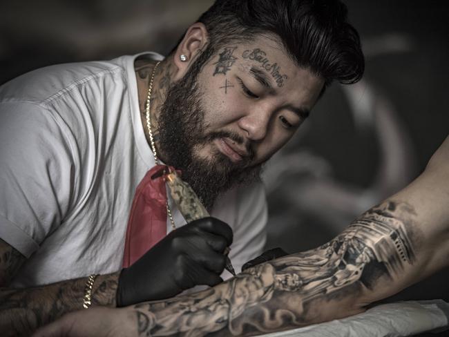 The tattoo artist hopes sharing his story will stop other young people from following the same dark path. Picture: Jason Edwards