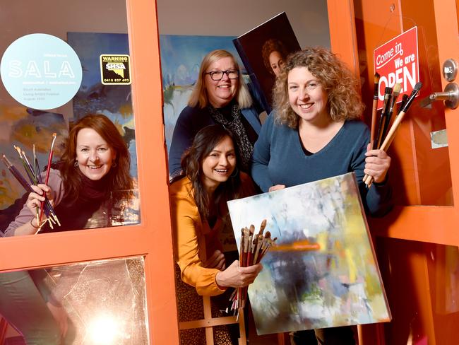 ADELAIDE, AUSTRALIA - August 7th 2020 -  Artists (L-R) Leah Jeffries, Sonali Patel, Carolyn Corletto and Cristina Metelli from the Collective Haunt studios at Norwood bursting through their doorway, welcoming people in to visit open studios on weekend as part of SALA Festival. Picture: Naomi Jellicoe