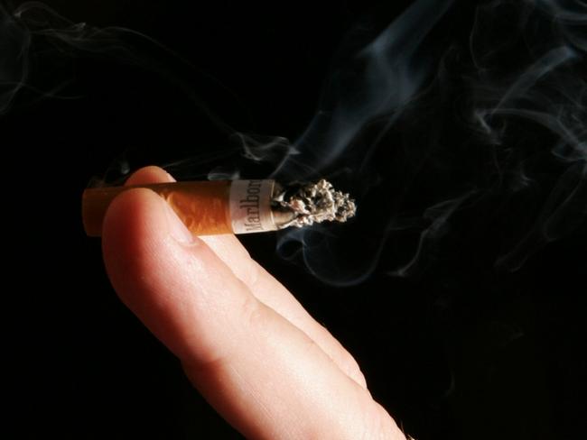 22/08/2005 WIRE: A man smokes a cigarette outside his London office 22 Aug 2005, on the day that a new survey has suggested the majority of people in England and Wales back a complete ban on smoking in workplaces : ALSO: generic smoking smokes smoker smoke . AFP PicJohn/D/Mchugh - men Pic. Afp