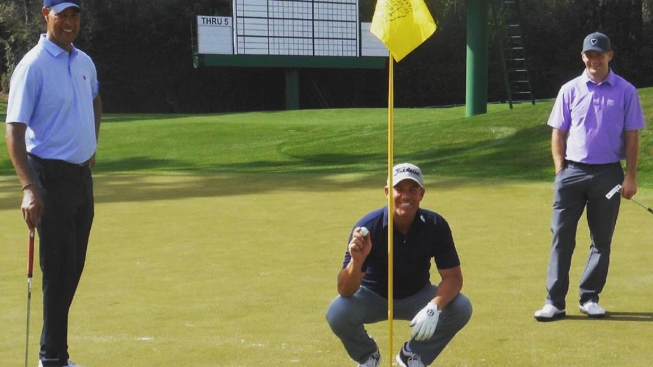 Shane Warne holds the ball up following his hole-in-one on the 16th at Augusta National in 2018. Photo: Instagram