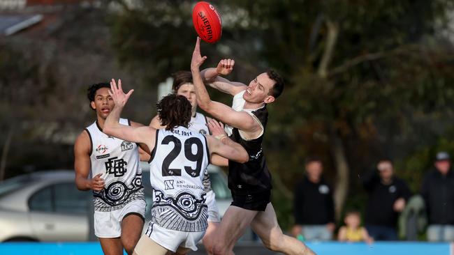 EFL: Ringwood’s James Parker flicks out a handpass. Picture: George Salpigtidis