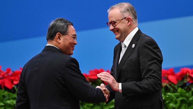 China's Premier Li Qiang and Anthony Albanese shake hands. (Photo by Hector RETAMAL / AFP)