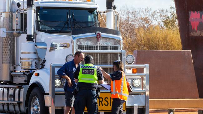 A road train and it's safety vehicle were the first to be stopped by NT Police at the NT/SA border after new NT entry restrictions came into effect at 4pm on 24 March 2020. Photo: EMMA MURRAY