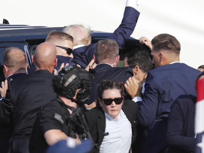 Former US President Donald Trump pumps his fist as he is rushed from the stage by secret service after an incident during a campaign rally at the Butler Farm Show Inc. in Butler, Pennsylvania, USA, 13 July 2024. Picture: David Maxwell/EPA/AAP