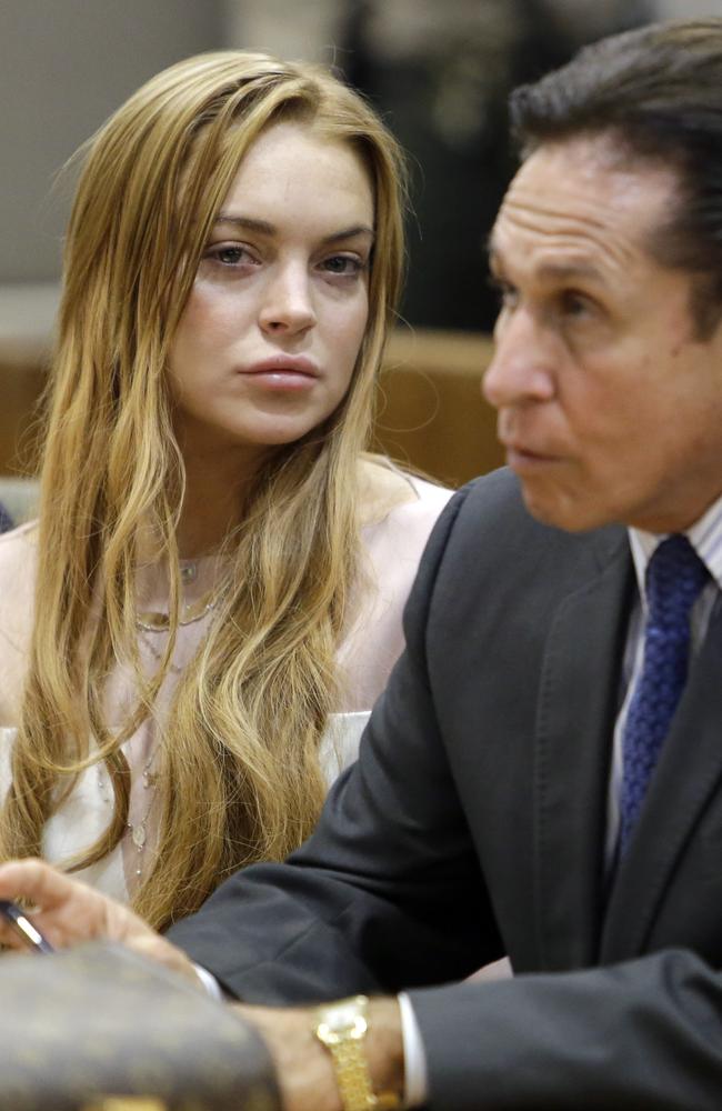 Lindsay Lohan and her lawyer Mark Heller appear in court in LA in 2013 over a misdemeanour car crash case. Picture: AP/Reed Saxon