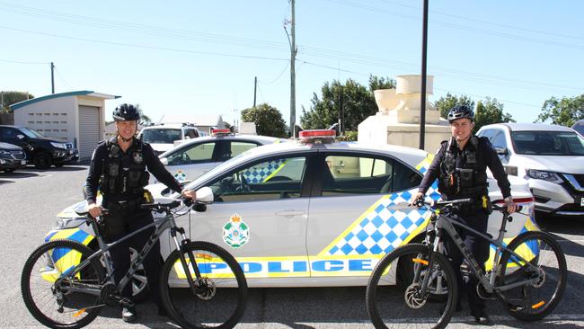 Gladstone Police constables Marcia Boyce and Jade Banks with two of the fleet of mountain bikes used by police in the region that were donated by Gladstone MP Glenn Butcher. Picture: Rodney Stevens