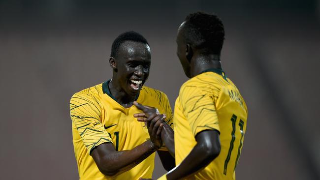 KUWAIT CITY, KUWAIT - OCTOBER 15:  Awer Mabil (R) of Australia celebrates with Thomas Deng (L) scoring his sides fourth goal during the International Friendly match between Kuwait and Australia at Al Kuwait Sports Club Stadium on October 15, 2018 in Kuwait City, Kuwait.  (Photo by Tom Dulat/Getty Images)