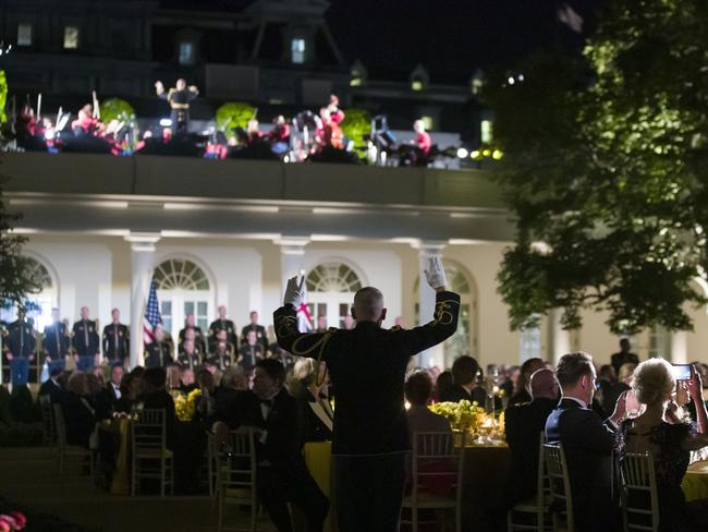 Guests listen to music in the Rose Garden of the White House during the State Dinner. Picture: AP