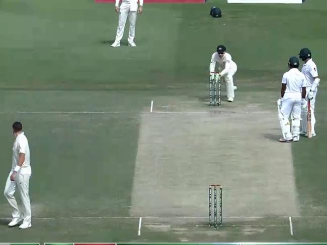 Azhar Ali stands mid-pitch as Tim Paine whips the bails off.